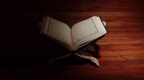 Open Quran on a wooden stand